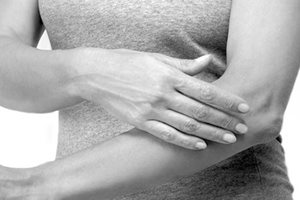 Woman touching her left arm